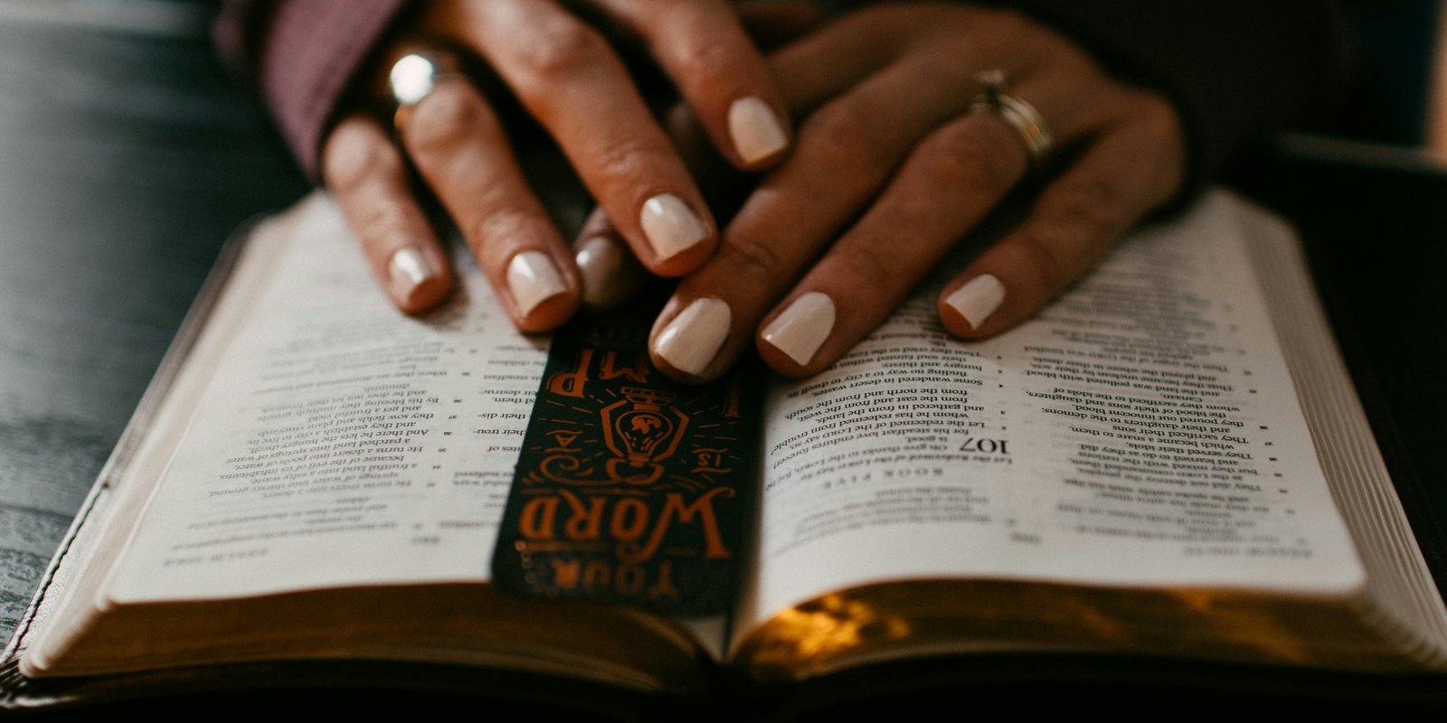 A couple sit outside reading their bibles